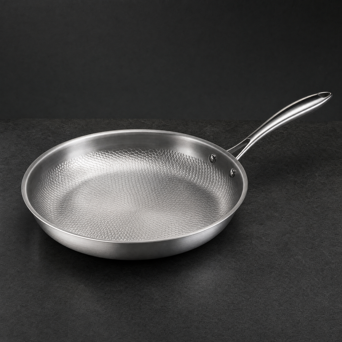 The Titanium Pan seen at a three quarter angle on charcoal stone