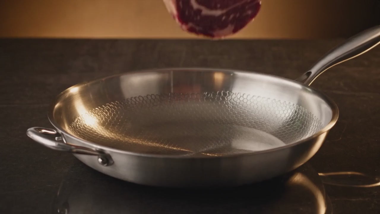 A steak searing, butter foaming